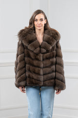 Short brown Russian sable jacket with a hood. Features a V chevron pattern throughout the body and long sleeves with an adjustable hem drawcord.