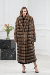 Long Russian sable fur coat in rich brown. The top features a grid-like block pattern, while the lower section has horizontal fur panels.