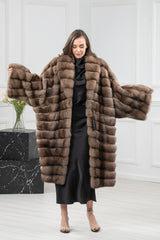 A Russian sable fur coat featuring horizontal panels on the body and wide sleeves, with a shawl collar, shown front-facing with arms extended.