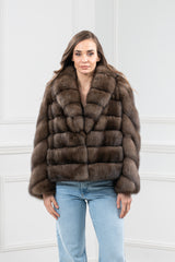 A short Russian sable fur jacket featuring a high collar and a panelled, horizontal-striped design in a deep brown tone.
