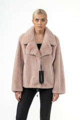Salmon mink fur jacket with a large notched collar, long wide sleeves, and a straight hem with an adjustable drawstring detail.