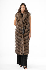 A sleeveless long Russian sable vest in a warm brown tone, featuring a V chevron fur pattern, wide lapels, and a straight knee-length silhouette.