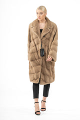 A sand mink fur jacket with an inverted V chevron pattern, notched collar, and a concealed button closure, shown from the front.