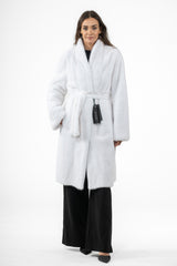 White mink fur jacket with a shawl collar, long sleeves, and a matching tie belt at the waist. Straight-cut silhouette with side pockets.