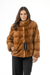 Gold mink fur short jacket with a stand-up collar and horizontal panels throughout. The jacket has long sleeves and a straight cut.