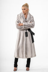 Silverblue cross mink fur coat with vertical striping, a wide collar, and a black leather waist belt, worn with arms crossed.