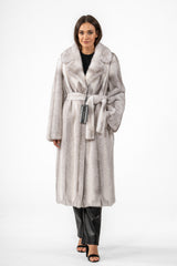 Silverblue Cross mink fur coat featuring a belted waist, long sleeves, and a wide collar. The fur is worked in vertical panels in grey and white.