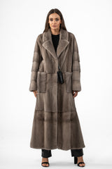 Full-length silver blue mink velvet coat with horizontal paneling on sleeves, large notch lapels, and deep vertical-set hip pockets.