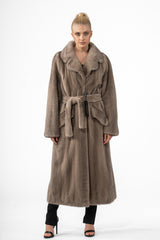 Silver blue mink fur coat featuring a wide collar, waist tie-belt, and two front pockets. Floor-length, straight silhouette on a model.