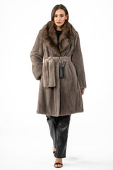 Silver blue mink fur jacket with a large fluffy fur collar, tied at the waist with a matching belt, worn over black leather pants.
