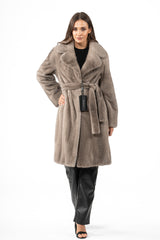 Silver blue mink fur jacket with a wide notched collar and a matching tie belt at the waist, worn over black leather-style trousers.
