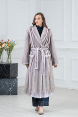 Full-length silver blue mink fur coat with vertical pelts, a wide shawl collar, and a matching fur tie belt at the waist.