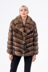 Short Russian sable jacket in brown, featuring a V-chevron pattern, a wide collar, and long sleeves on a model against a white background.