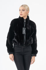Blackglama mink fur short jacket with horizontal panel construction, standing collar, front zip closure, and gathered elastic cuffs and hem.