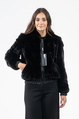 Front view of a Blackglama mink short jacket featuring a hood, front zip closure, and elasticized cuffs and hem on a solid black base.