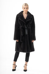 Iron grey mink fur jacket with a wide collar, knee length, and a matching fur tie belt worn over black pants.