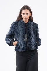 Front view of a Profondo blue Swakara jacket with a ribbed collar, black ribbed cuffs and waistband, central front zipper, and side pockets.