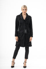Front view of a black Swakara skin jacket featuring a classic collar and long sleeves, showcasing the characteristic wavy, rippled fur texture.