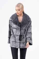 Short Swakara fur jacket with a grey mink collar, horizontal panel construction, and a silver-black moiré pattern, shown from the front.