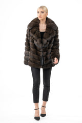 Dark Russian sable short jacket featuring a wide collar and horizontal pelt construction, worn over black slim-fit trousers.