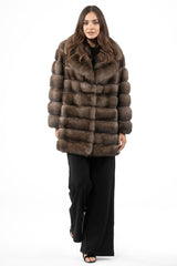 A mid-length Russian sable jacket in brown with a wide notched collar, featuring horizontal panels of fur and a relaxed, straight-cut fit.