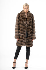Front view of a brown Russian sable jacket with a notched collar, featuring a V-chevron pattern on the body and sleeves, worn with black pants.