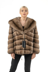 Short Russian sable jacket in light brown, featuring horizontal fur paneling and a large, wide hood.
