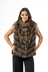 Short Russian sable vest in brown, featuring a V chevron fur pattern, high collar, and integrated side pockets with a front Manzari tag.