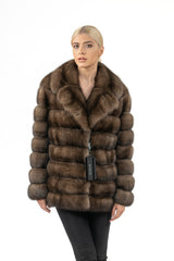 Front view of a gun metal Russian sable short jacket featuring horizontal fur panels and a wide collar, displayed on a model against white.