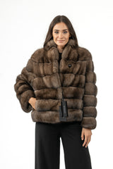 Short Russian sable jacket in brown with a block-patterned construction, high collar, and a single prominent button closure at the neck.