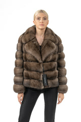 Short Russian sable jacket in brown with a wide collar and horizontal pelt construction, displayed on a model against a white background.