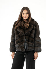A short, dark Russian sable jacket featuring an inverted chevron pattern, wide collar, and horizontal-banded sleeves, shown on a model.