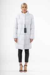 White mink fur jacket featuring horizontal panel construction, a stand-up collar, and a mid-thigh length silhouette, shown on a model from the front.