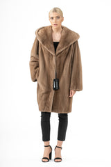 A knee-length pastel mink fur jacket with a large hood, featuring smooth, vertical fur pelts and a relaxed fit.