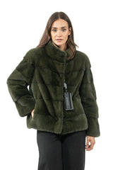Dark olive velvet mink fur short jacket with a high collar, featuring horizontal panels and a hidden front closure on a woman.