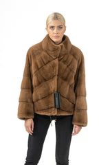 Maple mink short jacket with a tall collar and a V chevron pattern on the bodice. The long sleeves feature horizontal panels and a drawstring hem.