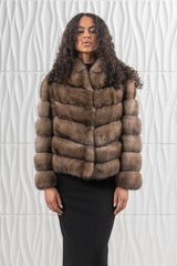 Front view of a brown Russian sable short jacket featuring a V chevron pattern throughout, a soft folded collar, and long sleeves.