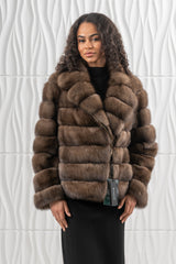 Short Russian sable jacket in brown with a high collar, featuring horizontal fur pelts and an asymmetrical zip front closure.