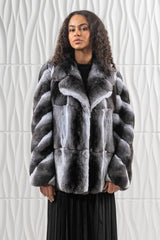 Natural chinchilla jacket with a wide collar, featuring horizontal panels on the body and V-chevron patterned fur on the sleeves.