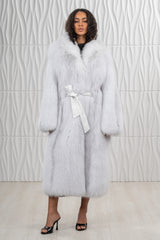 Arctic marble fox fur coat in a soft grey and white tone, featuring a wide collar and a white leather waist tie belt over a full-length silhouette.