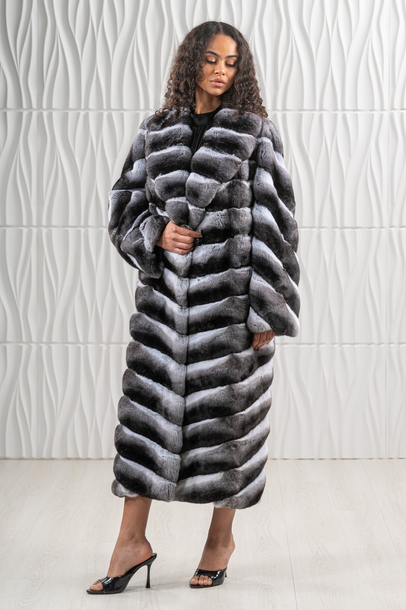 Model wearing a manzari chinchilla fur coat by manzari