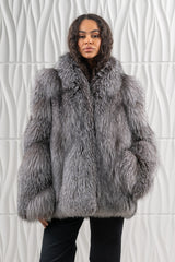 Front view of a blue frost fox fur jacket, featuring long, dense hair in shades of grey and charcoal with a voluminous collar and wide cuffs.