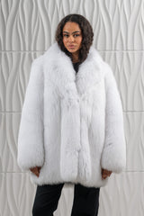 Short Shadow Blue Frost Fox fur jacket with a large, plush notched collar, long sleeves, and a straight hem, worn over a black shirt.