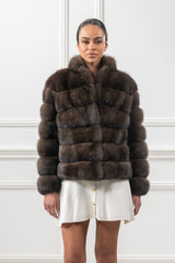 A short Russian sable jacket with horizontal fur panels, a fold-over collar, and a single round button closure at the top.
