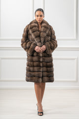 Front view of a brown Russian sable jacket with a wide collar and horizontal pelt construction, falling to mid-thigh.