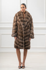 A mid-length Russian sable fur jacket featuring a V-chevron pattern, a notched collar, and full-length sleeves in a natural brown tone.