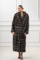 A full-length Russian sable fur coat in a rich brown tone. The design features horizontal panels and a wide, plush collar with long sleeves.
