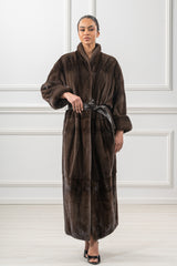 A dark brown velvet mink fur coat featuring a stand-up collar, wide sleeves with turn-up cuffs, and a matching leather waist tie.