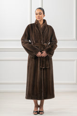 Full-length brown mink fur coat with a large collar and a matching tie-belt, featuring vertical pelts and a smooth, consistent texture.
