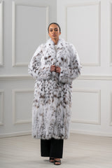 Full-length bobcat coat with white fur and dark brown spots. Features a large, wide collar, long sleeves, and a straight, clean silhouette.